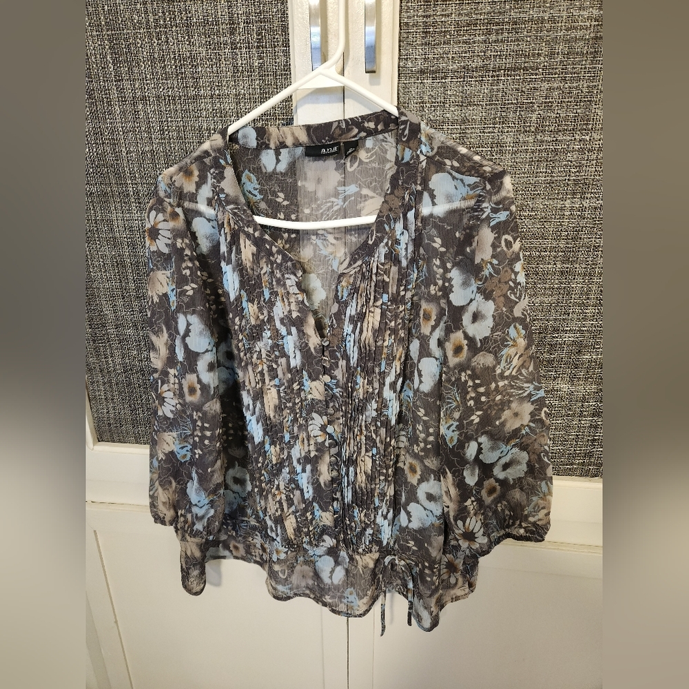 Pretty gray flowered blouse, a bit shear. Pleated front.